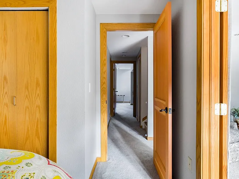 Basement bedroom off of basement living room opens to basement hallway