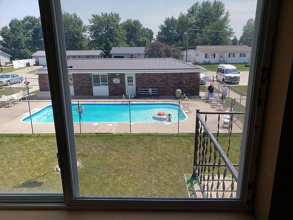 Living room overlooks pool and clubhouse