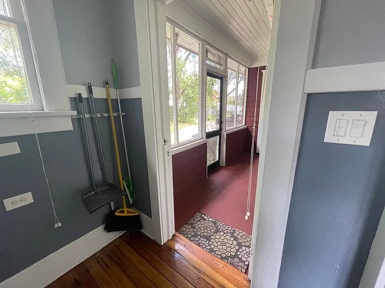 View out the backdoor in the laundry room to see screened porch in back which leads to the parking area.