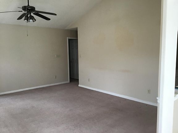 Living room has cathedral ceiling.
