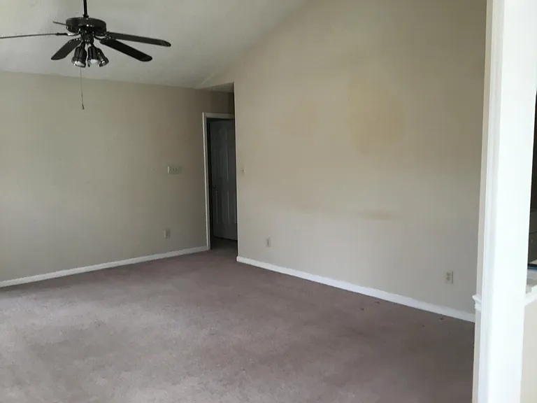 Living room has cathedral ceiling.