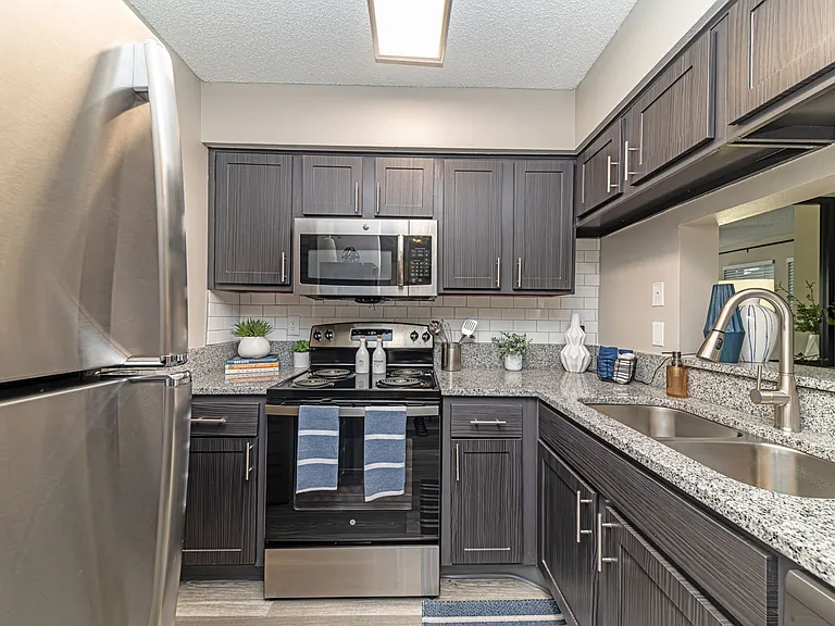 Kitchen with stainless appliances, granite counters, and modern cabinetry