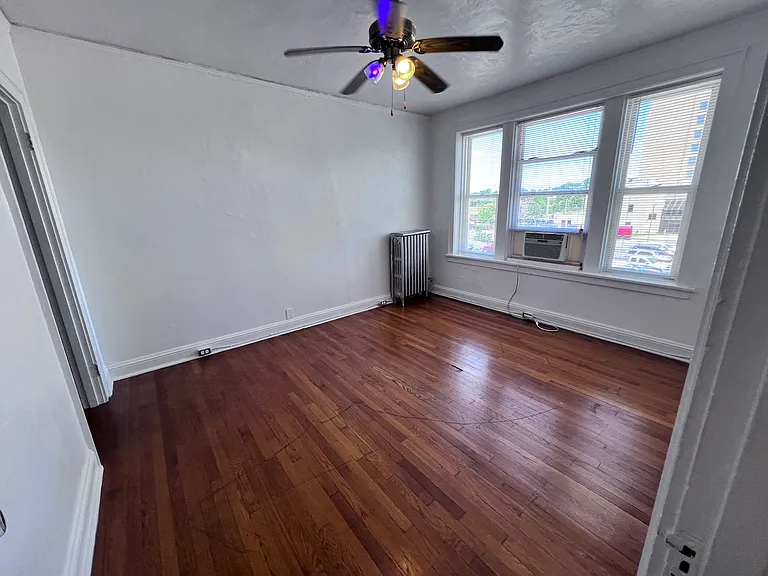 The bedroom has a walk in closet and so much natural light - A spacious retreat overlooking the neighborhood.