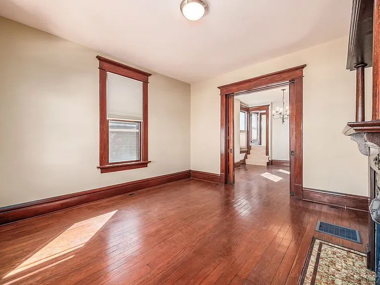 Original wood floors, pocket door separating dining and living rooms and plentiful natural light from south facing windows.