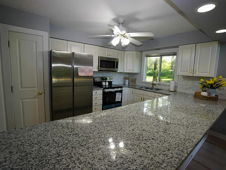 Kitchen with granite countertops and newer appliances.