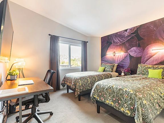 2nd bedroom with desk, smart TV and walk-in closet