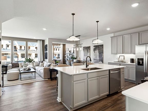 Standing in the Kitchen Looking into the Gathering Room, Sunroom, and Cafe