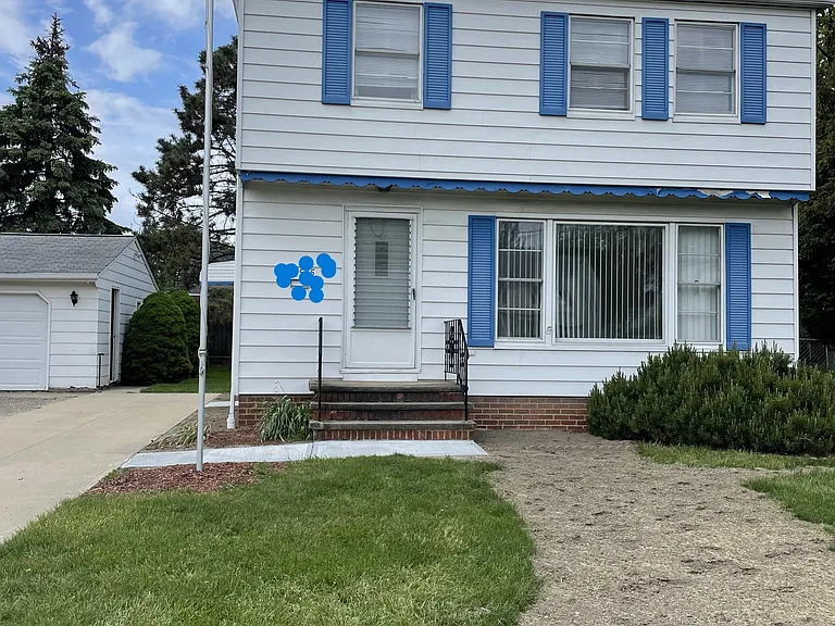 Front of house. Dirt part of lawn has been seeded for grass.
