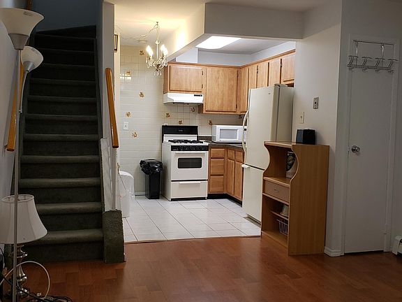 View of kitchen, closet, and steps from living room
