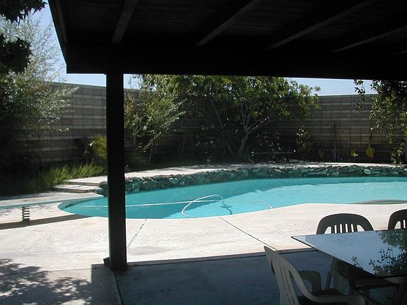 View From Kitchen Window thru Covered Patio to Pool