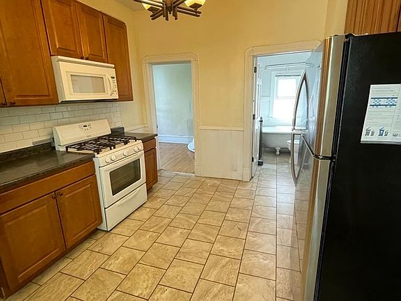 Kitchen is adjacent to bathroom and 3rd bedroom/office. Not pictured, to lower left of picture, is the back door with private stairwell to lower level door and back yard access.