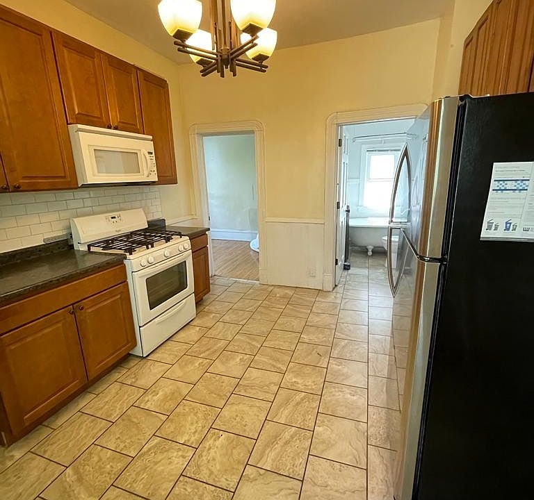 Kitchen is adjacent to bathroom and 3rd bedroom/office. Not pictured, to lower left of picture, is the back door with private stairwell to lower level door and back yard access.