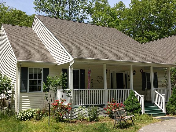 Large windows along back of house facing woods.