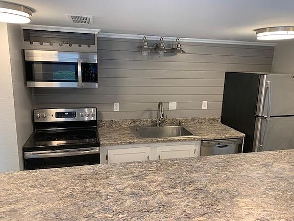 Up-to-date appliances, pantry and storage is under the raised bar. Smooth ceilings in the kitchen.