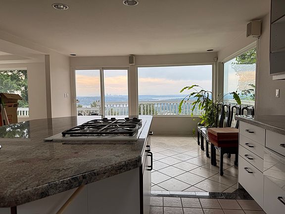 kitchen view facing outswards, additional seating area past kitchen island