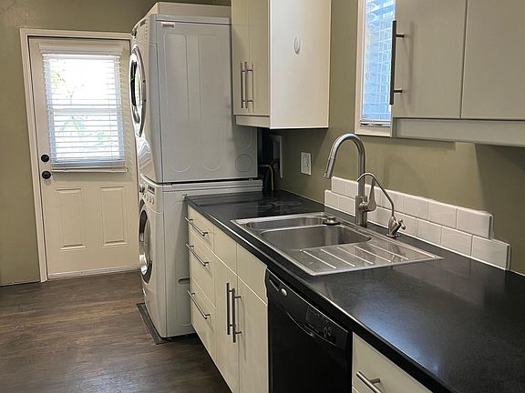 White cabinets and black counters give this galley kitchen a classic look and feel