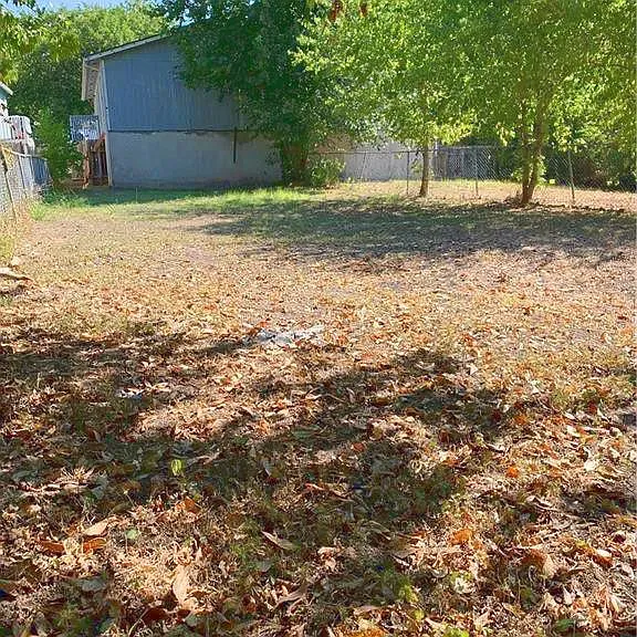 Very large backyard is fully fenced and not shared. Peaceful woods and dry creekbed beyond the fence. No neighbors behind you