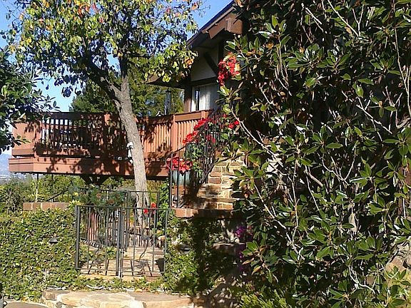 From side yard across front includes lower deck