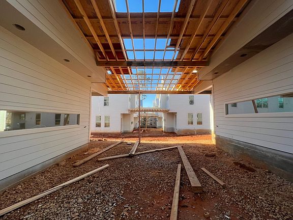 Looking through the common areas. These will be covered patios between the houses, perfect for hanging out! The long windows are in the kitchens and will be above the ranges and countertops like a backsplash.