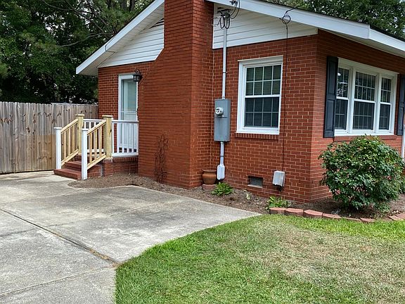 Side entrance with parking area.