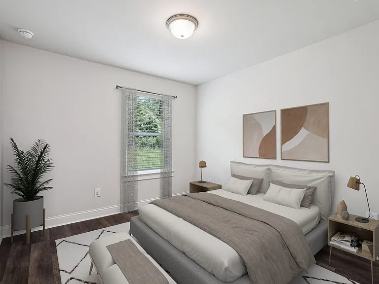 Secondary bedroom with queen size bed and large window letting in a ton of natural light.