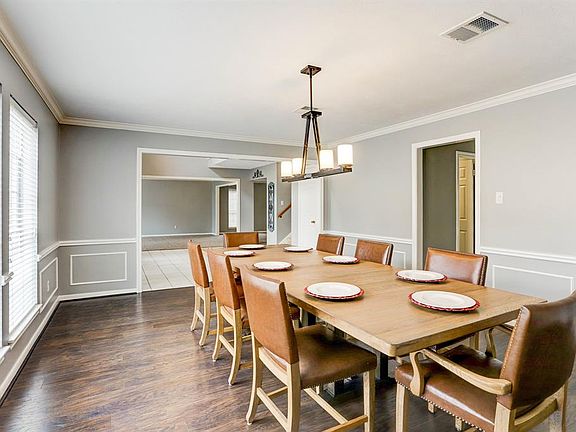 There is plenty of room to entertain in the Formal Dining room and easy care wood floor.
