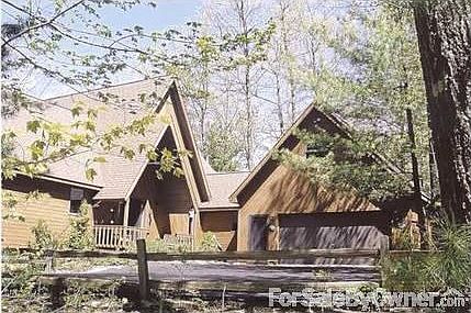 Front view with 2-car garage and loft
						:
						House sits on wooded 0.51-acre lot in private sub, across from wooded parcel
