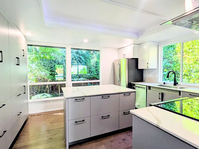 Kitchen newly renovated with new cabinets, appliances, countertops and windows