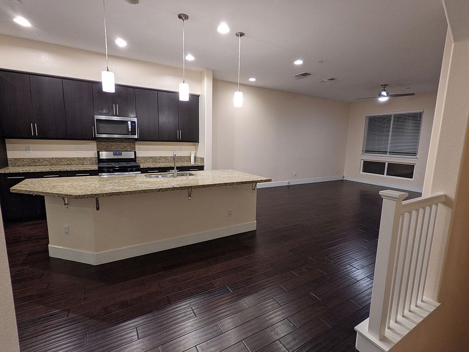 Open floor plan with living room, dining room, and kitchen.