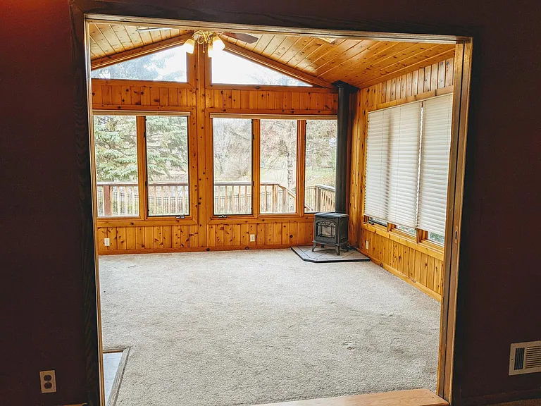 4 season porch off living room 1 with door to back yard deck