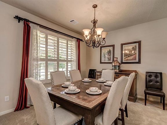 Formal dining room features plantation shutters.