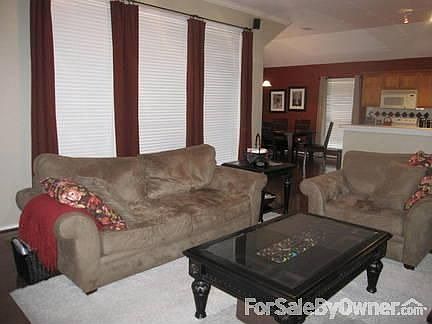 Living Room : Large windows with 2 inch wood blinds for ample natural lighting
