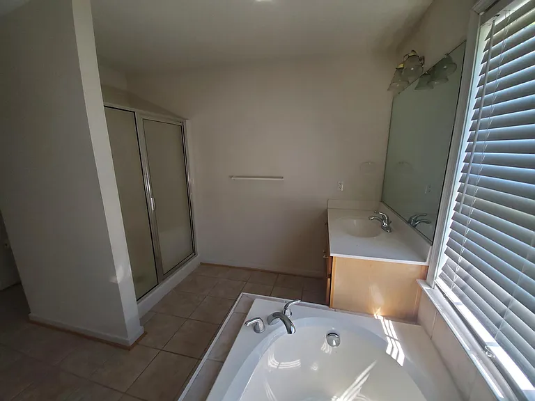 Master bathroom has tub and stand up shower.