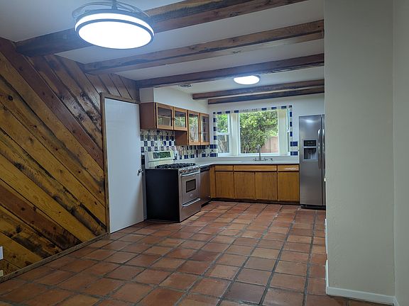 saltillo tile, vigas, real wood paneling, new lights and ceiling fan