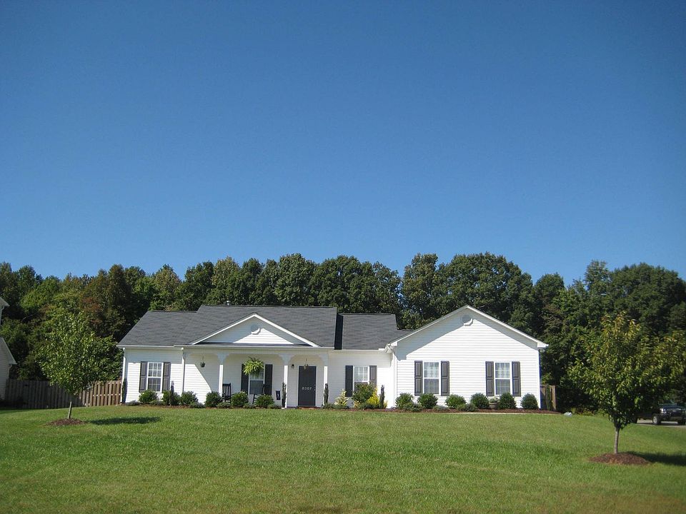 Front with rocking chair porch and pond view