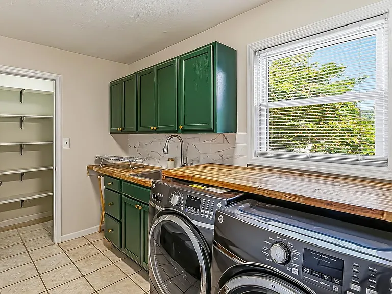 Ample space to fold clothes. Built-in sink to assist with stains and handwashed clothes. Ample storage in the closet!