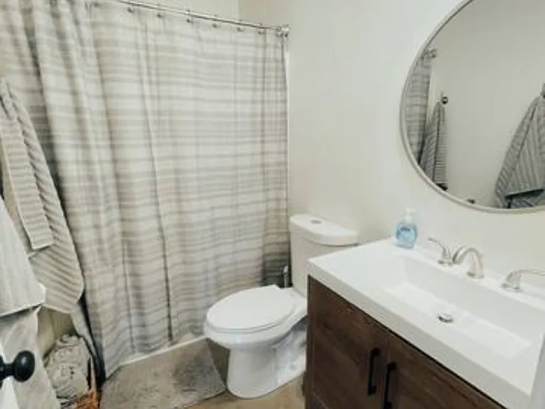 Full bath with shower over tub.