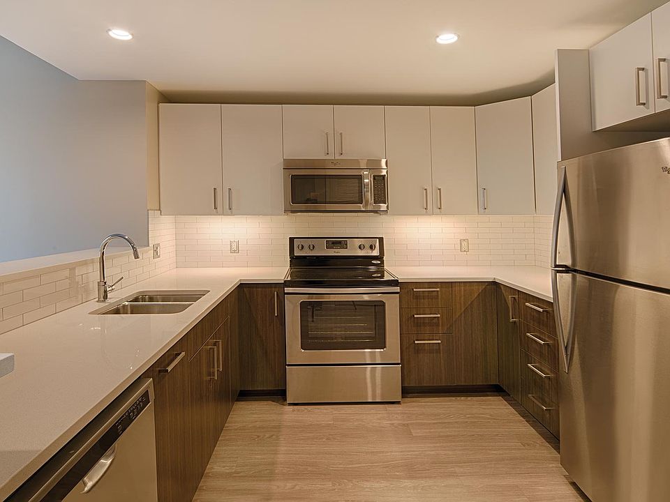 Modern kitchen with stainless steel appliances and quartz countertops