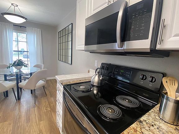 Kitchens feature stainless-steel appliances and granite-style countertops. Kitchens also open up to the separate dining area.