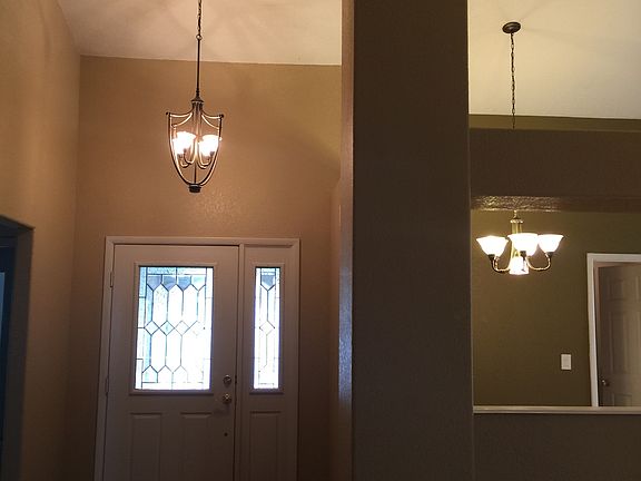 Lovely entry with decorator light fixtures throughout.