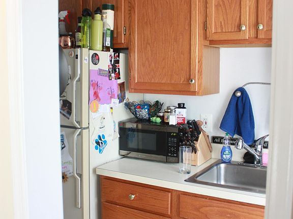 kitchen has new refrigerator, range, microwave and small dishwasher