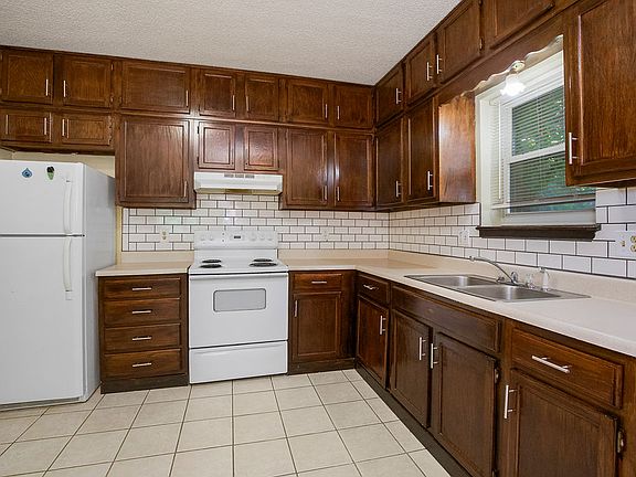 refrigerator, stove, sink, tons of cabinet space and countertop space for microwave