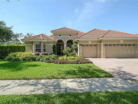 Front view with two story arched entry