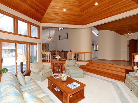 LR features a wall of windows and cedar ceiling.