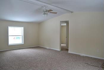 Huge living room with vaulted ceiling and updated carpeting throughout.  The open concept of the home provides great flow from the living room to the kitchen and dining areas.