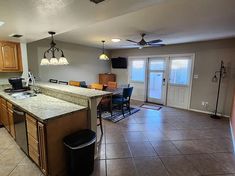 Spacious dining room and breakfast bar leading to covered patio.