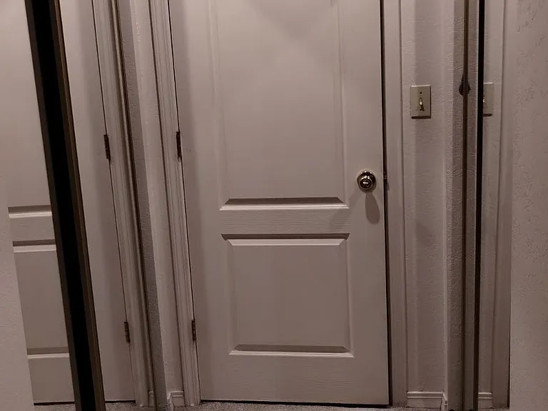 Leaving the master room. Mirrored sliding closet doors on each side.
