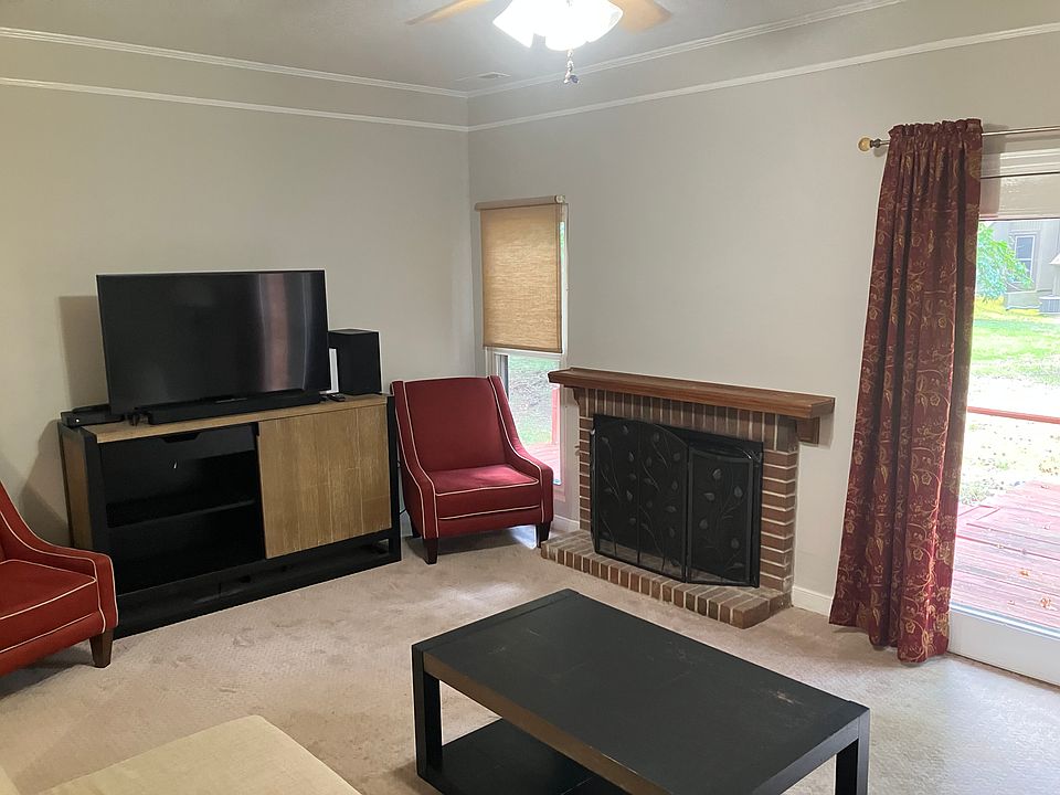 TV room with gas fireplace and access to back deck