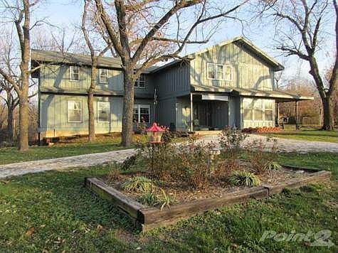 Front view of home nestled on a quiet 9.93 acre setting.