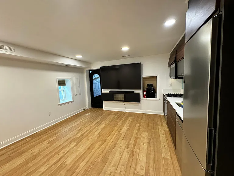 Kitchen and living-room area with rear entrance.